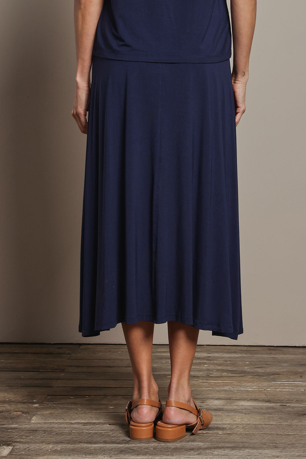 Model Amanda wearing size 10 of The Mix Me Match Me Bamboo Full Skirt in colour Darknavy (Blue), from the back