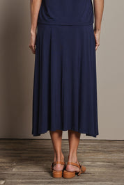 Model Amanda wearing size 10 of The Mix Me Match Me Bamboo Full Skirt in colour Darknavy (Blue), from the back