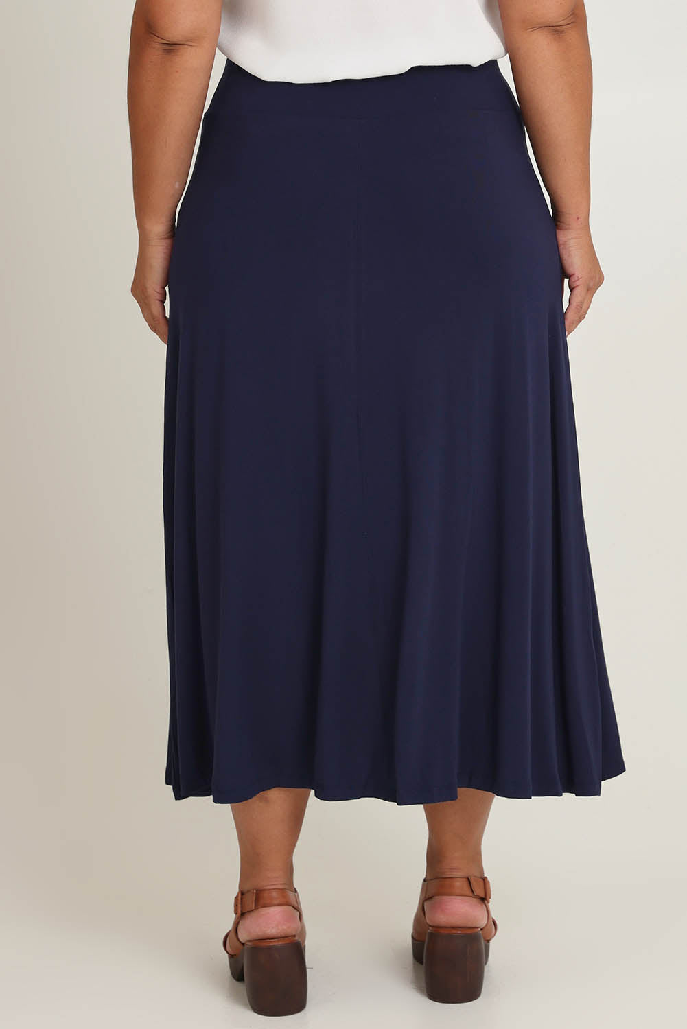 Model Ashleigh wearing size 16 of The Mix Me Match Me Bamboo Full Skirt in colour Darknavy (Blue), from the back
