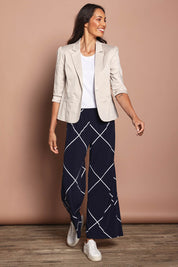 Model Amanda wearing size 10 of The Easy Wear Printed Pull On Wide Leg Pant in colour Navywhite (Blue), from the front, showing the whole outfit