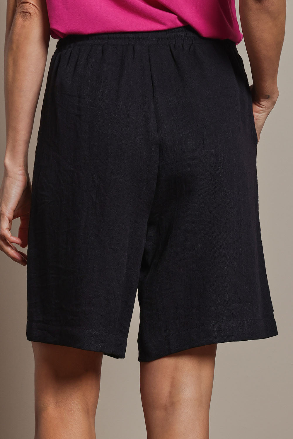 Model Amanda wearing size 10 of The Must Have Linen Look Pull On Shorts in colour Black (Black), from the back