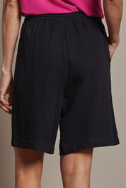 Model Amanda wearing size 10 of The Must Have Linen Look Pull On Shorts in colour Black (Black), from the back