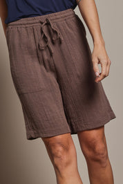 Model Abby wearing size 10 of The Must Have Linen Look Pull On Shorts in colour Cocoa, from the front, cropped image
