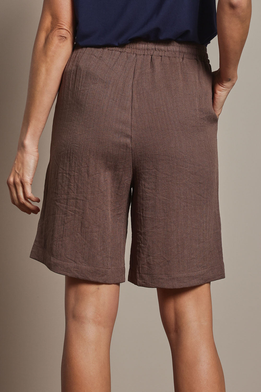 Model Amanda wearing size 10 of The Must Have Linen Look Pull On Shorts in colour Cocoa, from the back
