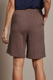 Model Amanda wearing size 10 of The Must Have Linen Look Pull On Shorts in colour Cocoa, from the back