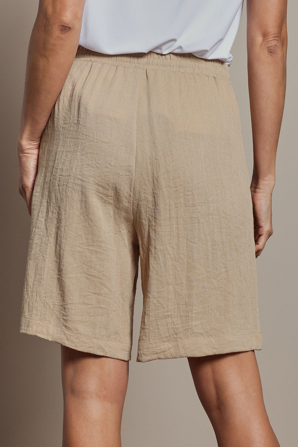 Model Amanda wearing size 10 of The Must Have Linen Look Pull On Shorts in colour Naturals, from the back