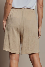 Model Amanda wearing size 10 of The Must Have Linen Look Pull On Shorts in colour Naturals, from the back