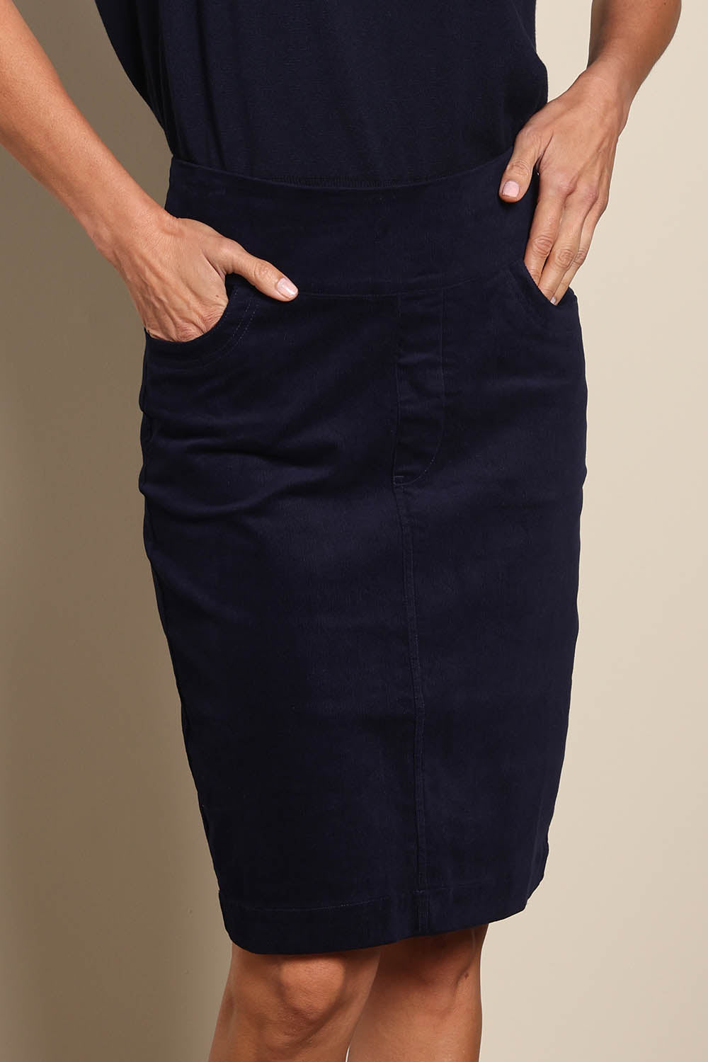 Model Amandam wearing size 10 of the The Keepers Cord Pull On Skirt – Darknavy in colour Darknavy, in a cropped view