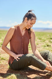 Model Amanda wearing size S of The Every Wear Knit Button Up Vest in colour Brick, from the front, showing the whole outfit