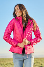 Model Amanda wearing size S of The Keepers Puffer Jacket in colour Hotpink (Pink), from the front, showing the whole outfit