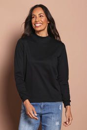 Model Amanda wearing The Cotton Blend Skivvy in colour Black (Black), from the front, cropped image