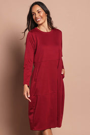 Model Amanda wearing size 10 of The Easy Wear Pocket Dress in colour Port (Red), from the front, cropped image