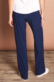 Model Madeline wearing size 10 of The Travel Wide Leg Pant in colour Navy (Blue), from the back