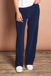 Model Madeline wearing size 10 of The Travel Wide Leg Pant in colour Navy (Blue), from the front, cropped image
