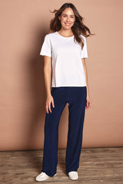 Model Madeline wearing size 10 of The Travel Wide Leg Pant in colour Navy (Blue), from the front, showing the whole outfit