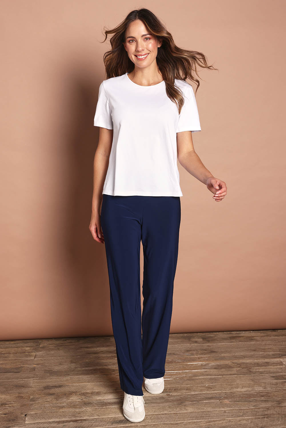 Model Madeline wearing size 10 of The Travel Wide Leg Pant in colour Navy (Blue), from the front, showing the whole outfit