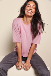 Model Amandam wearing size 10 of the The Essential Knit Tee – Blushcandy in colour Blushcandy, in a cropped view
