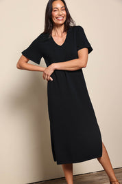 Model Amandam wearing size 10 of the The Summer Comfort True Knit Dress – Black in colour Black, from the front