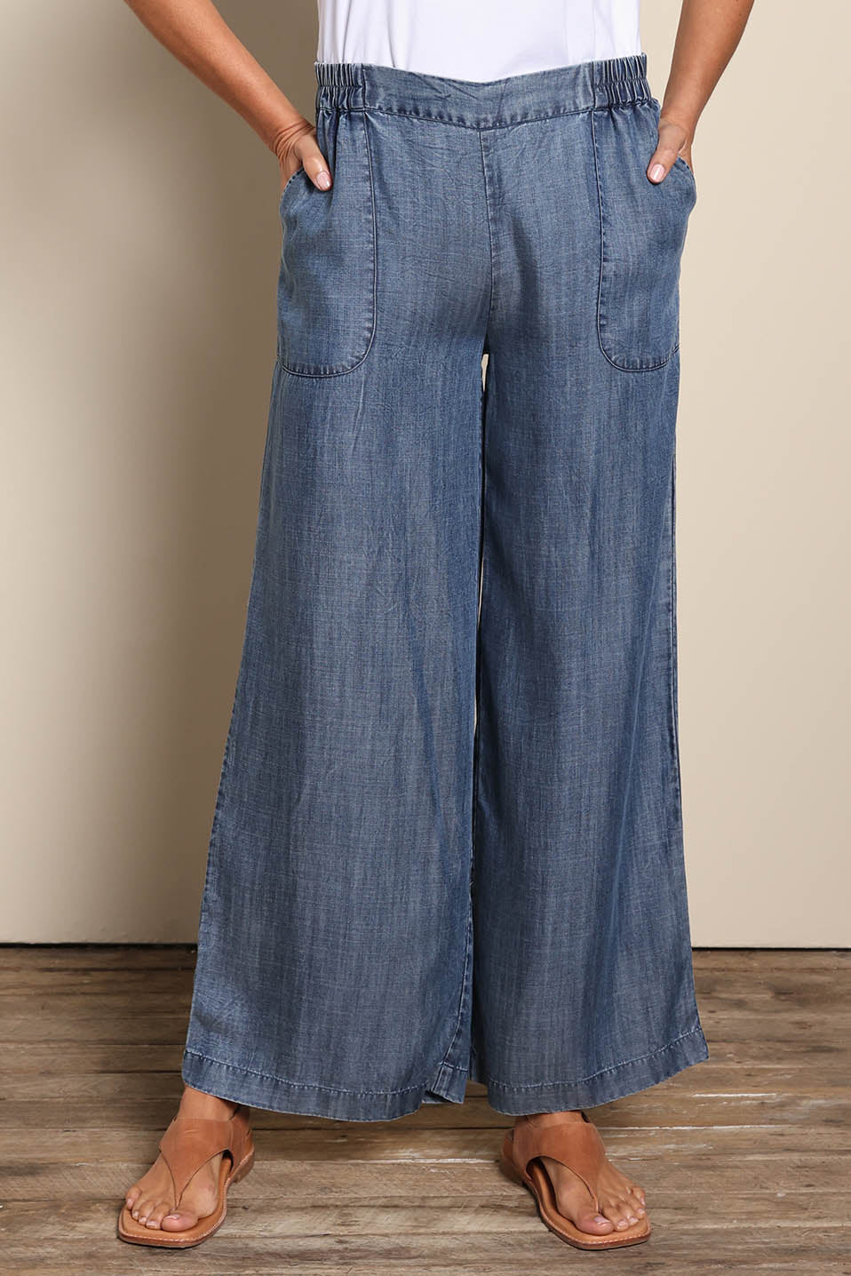 Model Amandam wearing size 10 of the The Luxe Lyocell Pull On Wide Leg Pant – Indigo in colour Indigo, in a cropped view