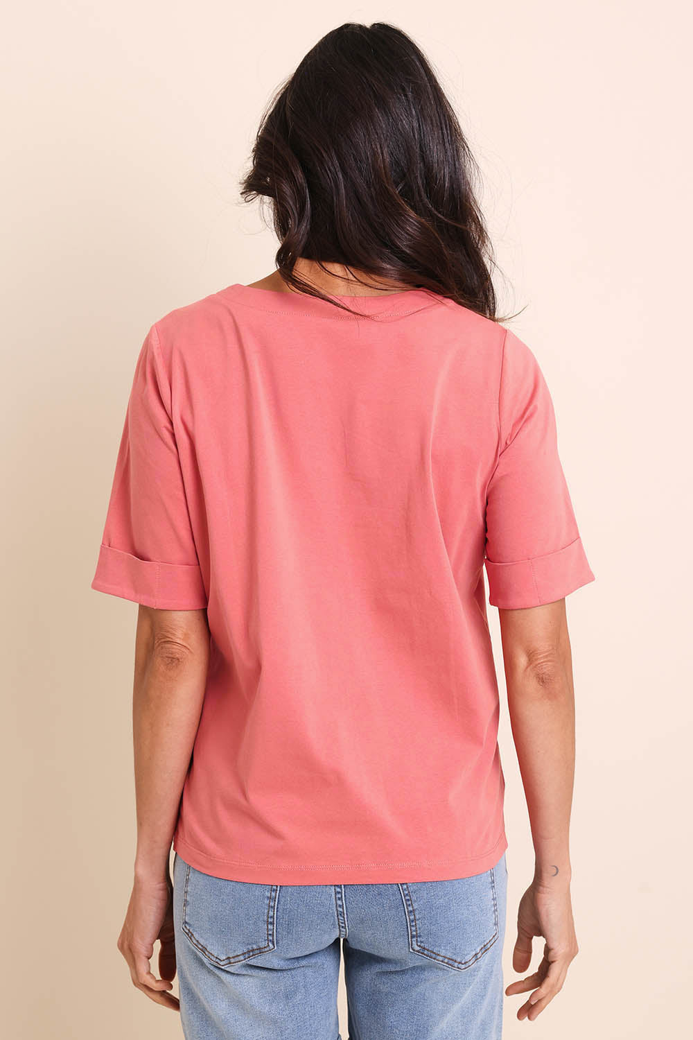 Model Amandam wearing size 10 of the The Keepers Relaxed Fit Tee – Papaya in colour Papaya, from the back