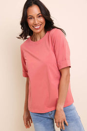 Model Amandam wearing size 10 of the The Keepers Relaxed Fit Tee – Papaya in colour Papaya, in a cropped view