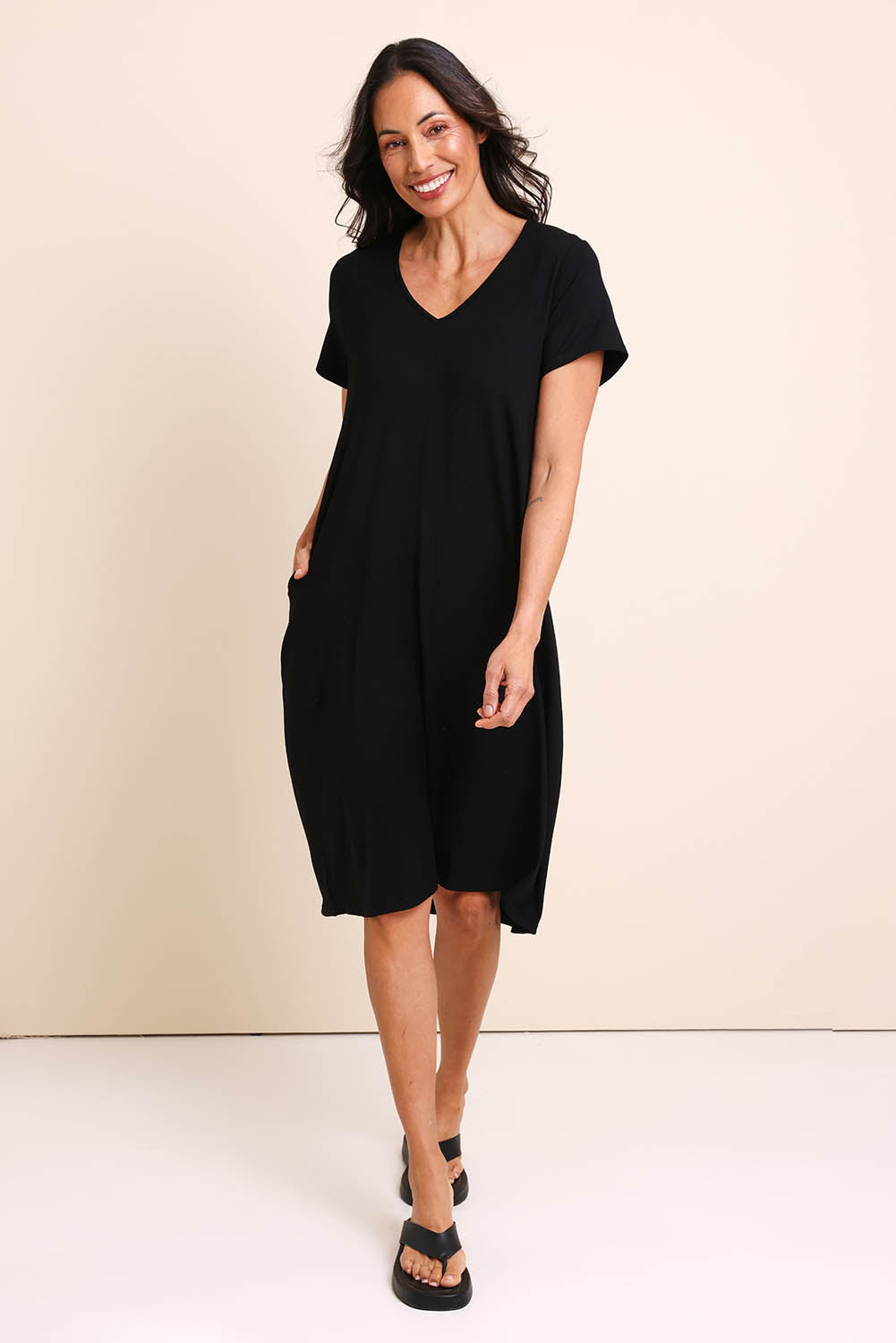 Model Amandam wearing size 10 of the The Easy Wear Bamboo Tee Dress – Black in colour Black, from the front