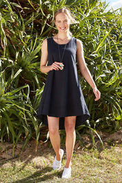 Model Alex wearing size 8 of The Sleeveless Swing Dress in colour WashBlack (Black), from the front, showing the whole outfit
