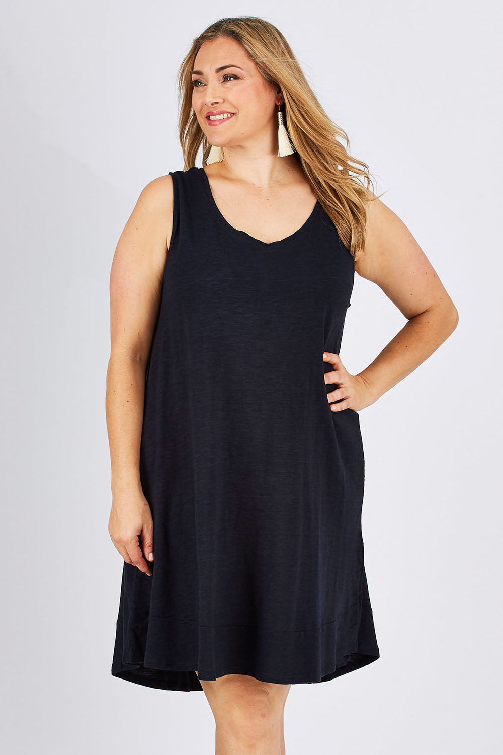 Model Ljubenka wearing size 18 of The Sleeveless Swing Dress in colour WashBlack (Black), from the front, cropped image