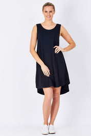 Model Maddy wearing size 10 of The Sleeveless Swing Dress in colour WashBlack (Black), from the front, showing the whole outfit