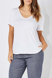 Model Laura wearing size 12 of The Bamboo Tee in colour White (White), from the front, cropped image