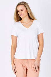 Model Maddy wearing size 10 of The Bamboo Tee in colour White (White), from the front, cropped image