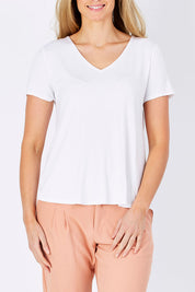 Model Maddy wearing size 10 of The Bamboo Tee in colour White (White), from the front, cropped image