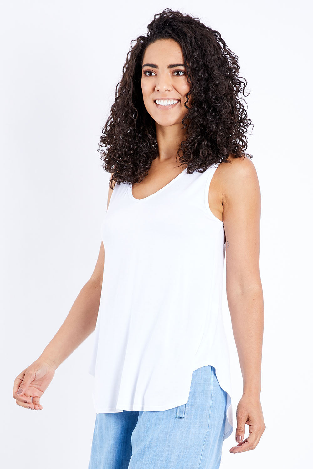 Model Pamela wearing size 10 of The Bamboo Tank in colour White (White), from the front, cropped image