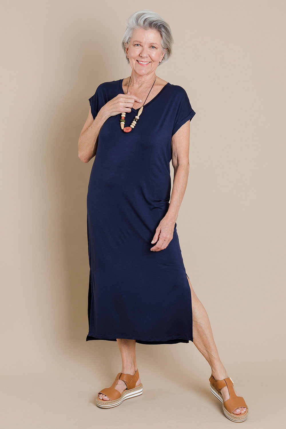 Model Elise wearing size 10 of The Mid Length Tee Dress in colour Navy (Blue), from the front, showing the whole outfit