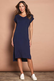 Model Madeline wearing size 10 of The Mid Length Tee Dress in colour Navy (Blue), from the front, showing the whole outfit