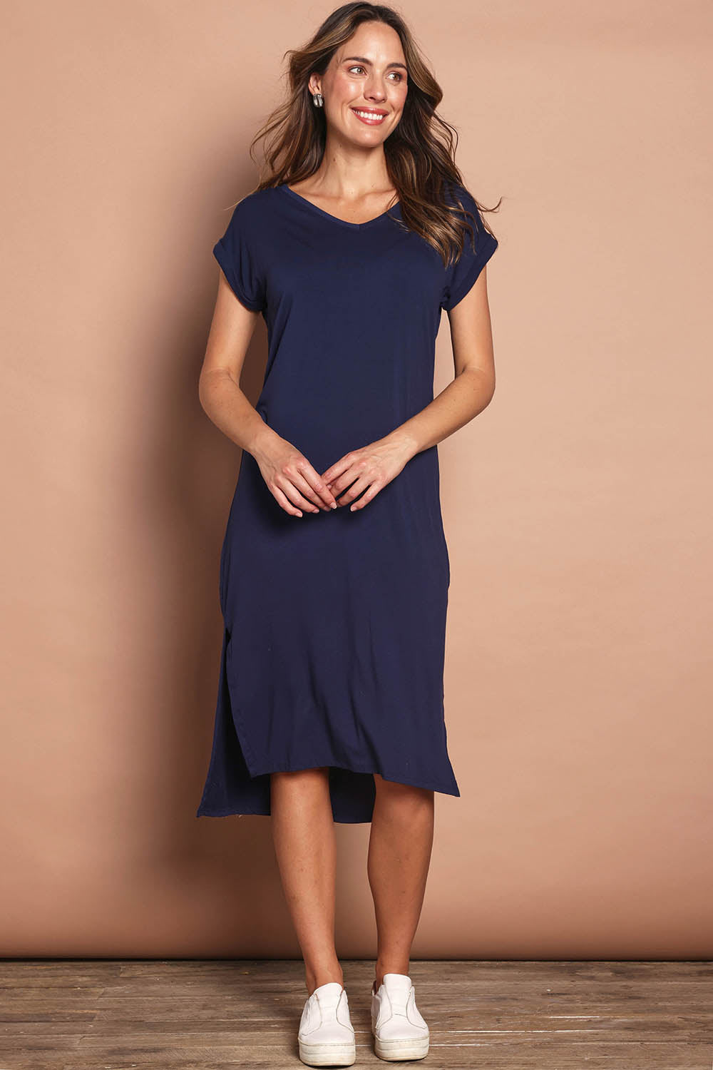 Model Madeline wearing size 10 of The Mid Length Tee Dress in colour Navy (Blue), from the front, showing the whole outfit