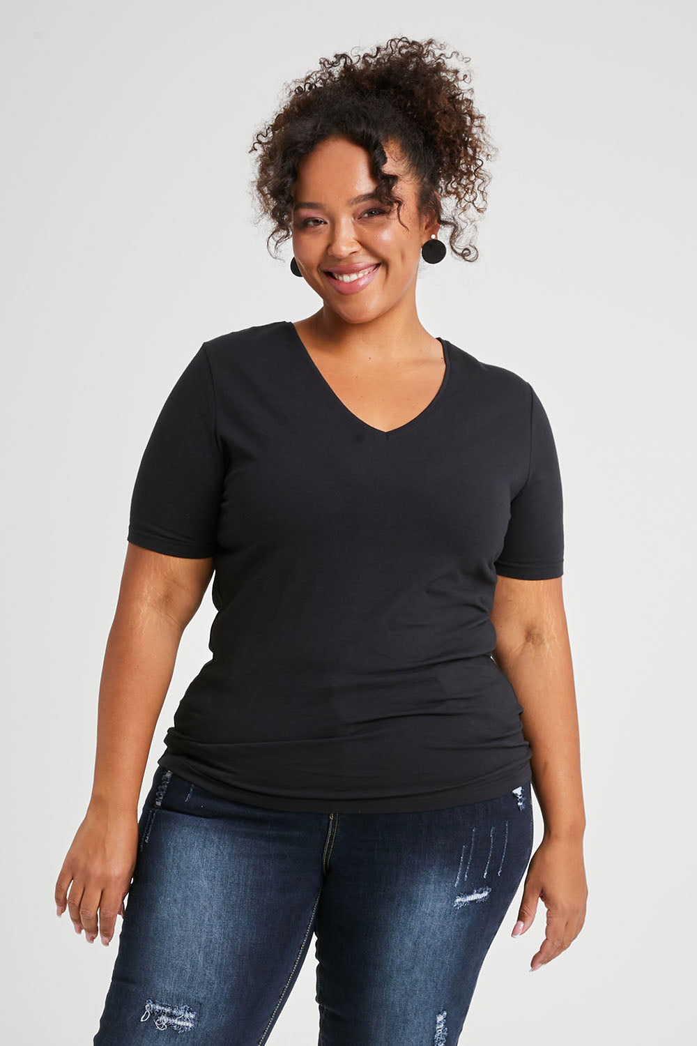 Model Alexis wearing size 16 of The Half Sleeve Tee in colour Black (Black), from the front, cropped image
