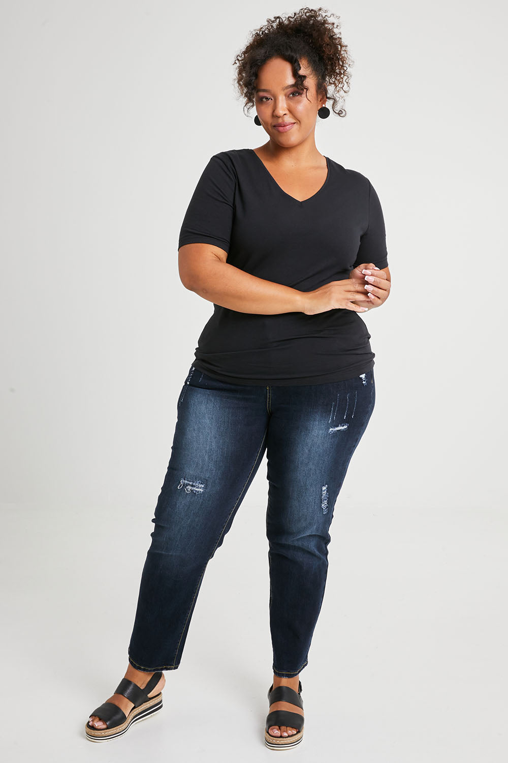 Model Alexis wearing size 16 of The Half Sleeve Tee in colour Black (Black), from the front, showing the whole outfit