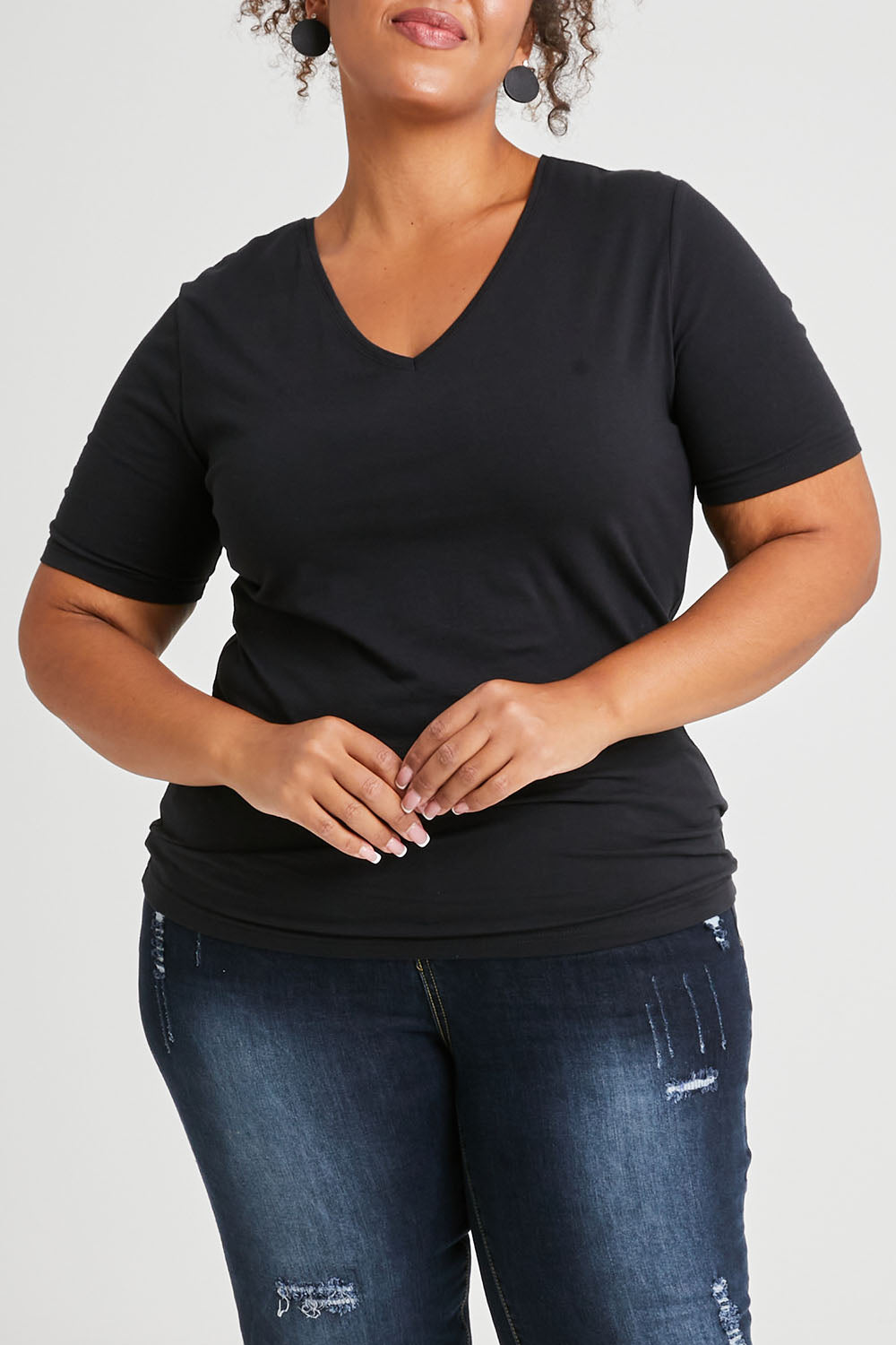 Model Alexis wearing The Half Sleeve Tee in colour Black (Black), from the front, cropped image