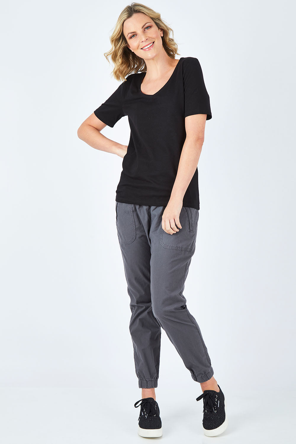 Model Chelsea wearing size 10 of The Half Sleeve Tee in colour Black (Black), from the front, showing the whole outfit