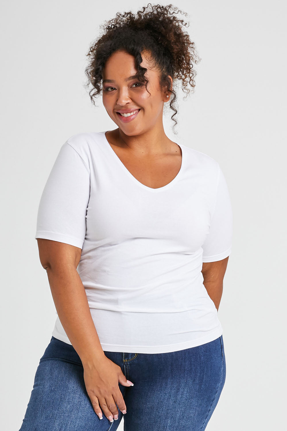 Model Alexis wearing size 16 of The Half Sleeve Tee in colour White (White), from the front, cropped image