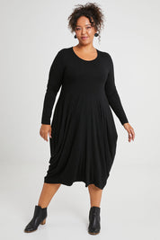 Model Alexis wearing size 16 of The Bounce Dress in colour Black (Black), from the front, showing the whole outfit