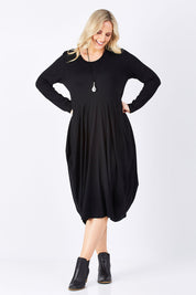 Model Jess wearing size 14 of The Bounce Dress in colour Black (Black), from the front, showing the whole outfit
