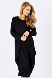 Model Marnee wearing size 10 of The Bounce Dress in colour Black (Black), from the front, cropped image