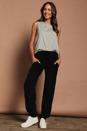 Model Madeline wearing size 10 of The Soft Utility Pant in colour Black (Black), from the front, showing the whole outfit