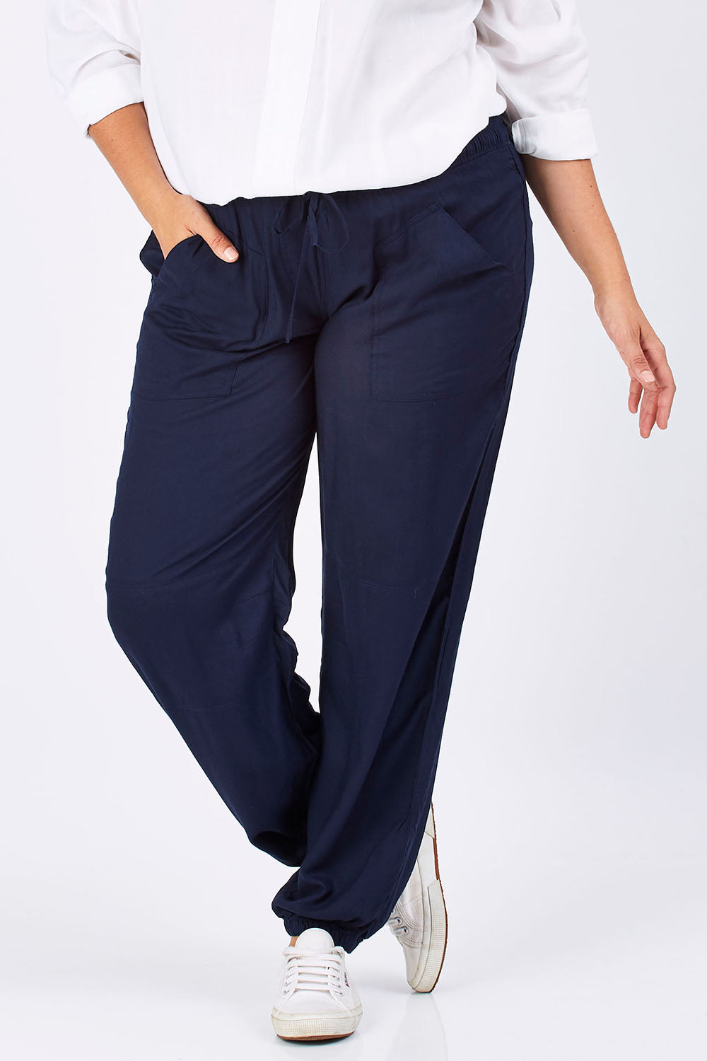 Model Mae wearing size 18 of The Soft Utility Pant in colour Navy (Blue), from the front, cropped image