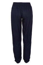 Product shot of The Soft Utility Pant in colour Navy (Blue), from the back