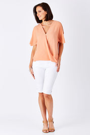 Model Perrie wearing size 10 of The Cut Out Shoulder Blouse in colour Clay, from the front, showing the whole outfit