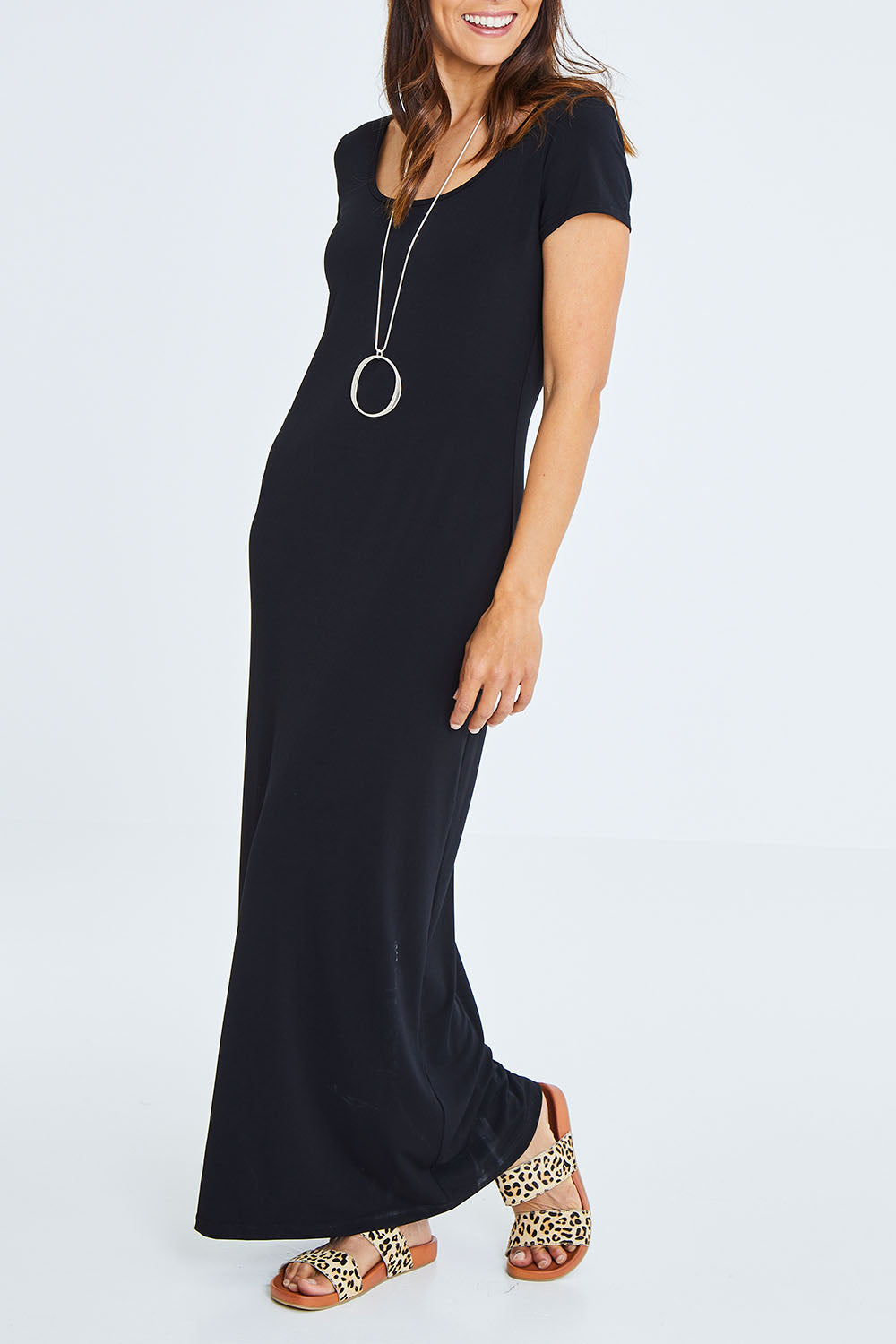 Model Cara wearing size 10 of The Cap Sleeve Maxi Dress in colour Black (Black), from the front, cropped image
