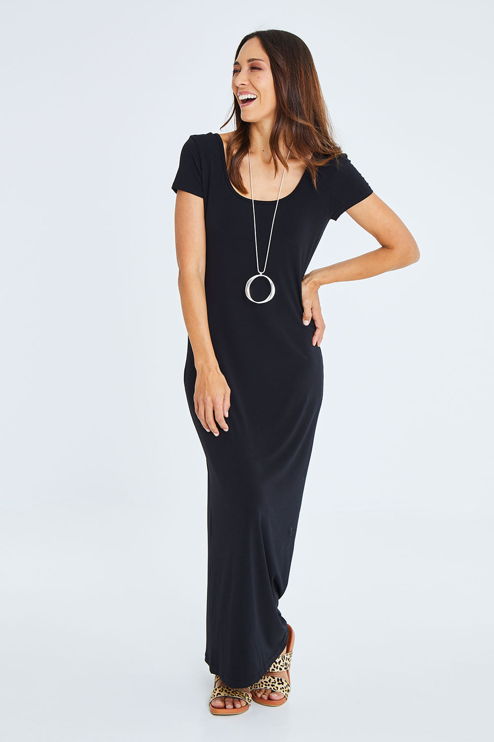 Model Cara wearing size 10 of The Cap Sleeve Maxi Dress in colour Black (Black), from the front, showing the whole outfit
